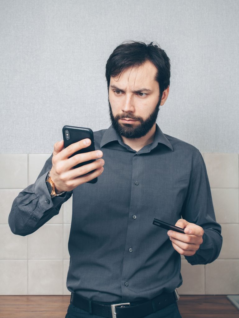 person checking phone after noticing signs it may be hacked