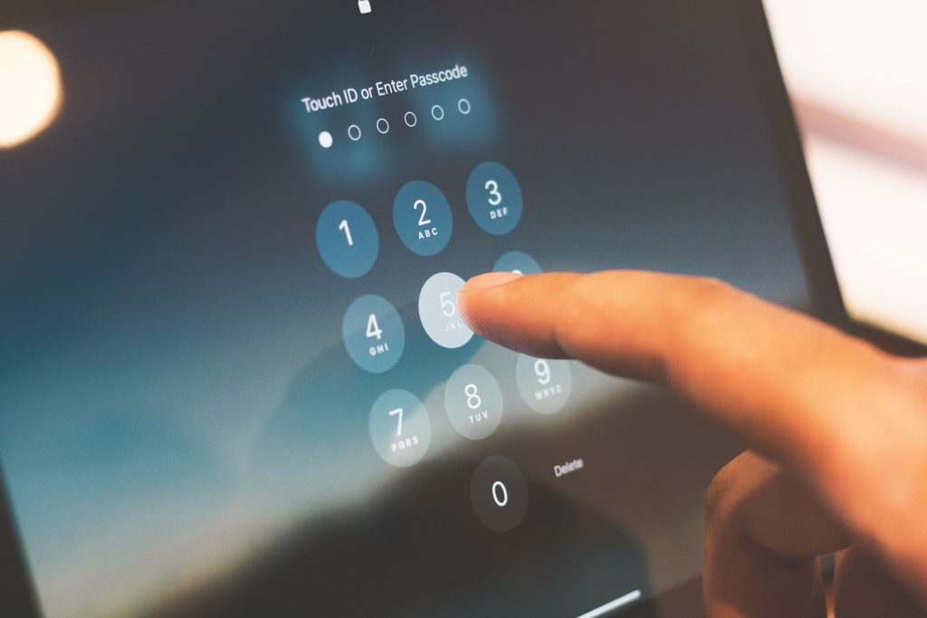 typing password pin code on smartphone screen for security
